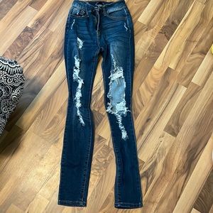 fashion nova dark washed ripped jeans on front and back